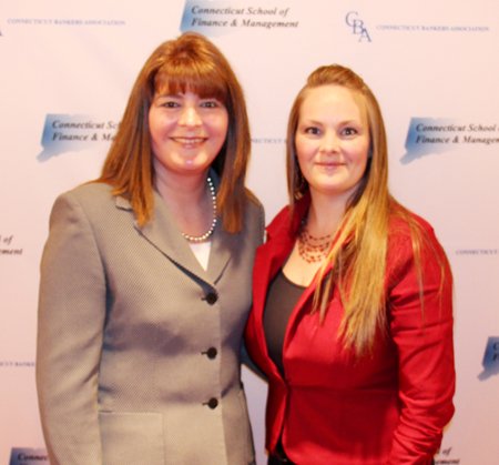 A portrait of Jennifer DeLucia and Kristen Scott in front of a white backdrop with blue Connecticut Bankers Association logos
