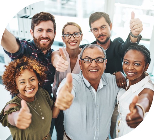 A diverse group of 6 people smiling and giving the camera thumbs