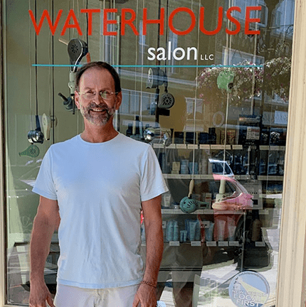 Richard Waterhouse smiling outside of Waterhouse Salon